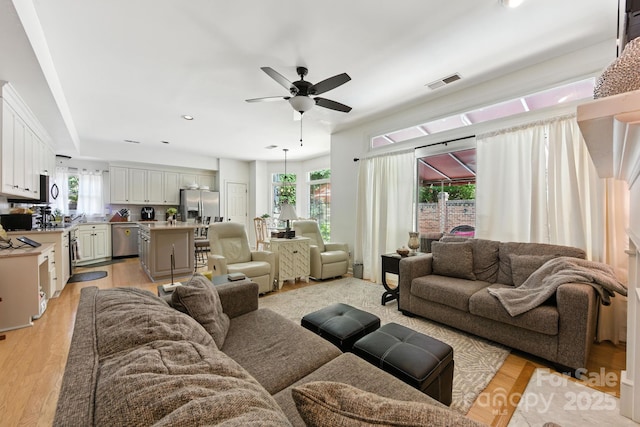 7014 Walton Heath Ln, Charlotte, NC 28277 - living area with healthy amount of natural light, ceiling fan, light wood-type flooring, and recessed lighting