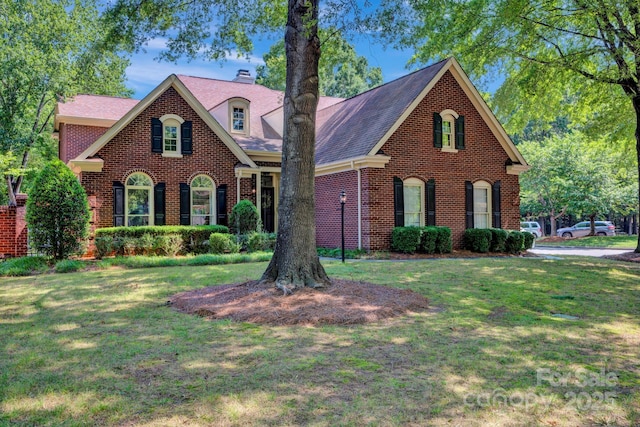 7014 Walton Heath Ln, Charlotte, NC 28277 - view of front of house with brick siding, a front lawn, and roof with shingles