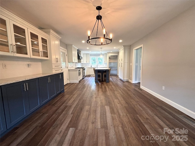 1335 33rd Avenue Dr NE, Hickory, NC 28601 - kitchen featuring a chandelier, high end stainless steel range, white cabinetry, recessed lighting, and backsplash