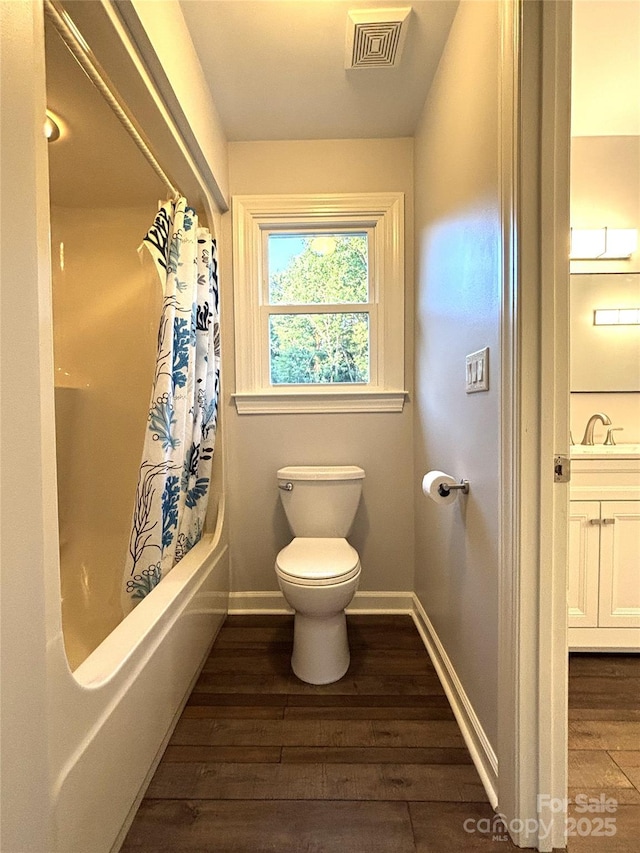1335 33rd Avenue Dr NE, Hickory, NC 28601 - bathroom featuring wood finished floors, vanity, and shower / tub combo