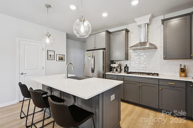 5008 Calvine Mill Way, Charlotte, NC 28205 - kitchen featuring appliances with stainless steel finishes, wall chimney exhaust hood, light wood finished floors, decorative backsplash, and recessed lighting