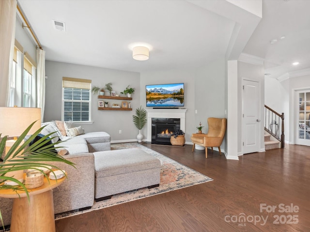 1008 Whipcord Dr, Waxhaw, NC 28173 - living room featuring a glass covered fireplace, wood finished floors, stairway, ornamental molding, and recessed lighting