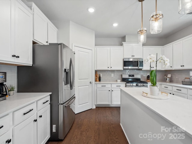 1008 Whipcord Dr, Waxhaw, NC 28173 - kitchen with appliances with stainless steel finishes, decorative backsplash, white cabinets, dark wood-style flooring, and recessed lighting