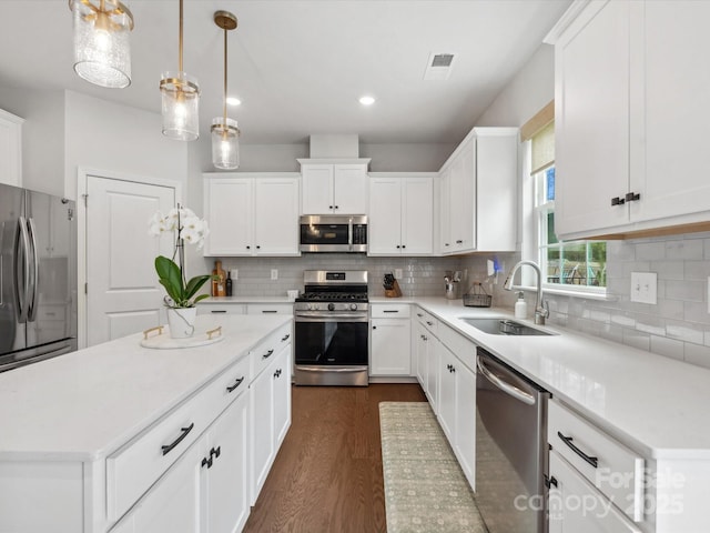1008 Whipcord Dr, Waxhaw, NC 28173 - kitchen with stainless steel appliances, dark wood finished floors, decorative backsplash, a center island, and recessed lighting