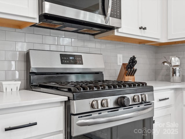 1008 Whipcord Dr, Waxhaw, NC 28173 - kitchen with appliances with stainless steel finishes, backsplash, white cabinets, and light countertops