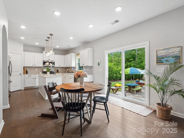 1008 Whipcord Dr, Waxhaw, NC 28173 - dining space featuring dark wood-style floors, recessed lighting, and arched walkways
