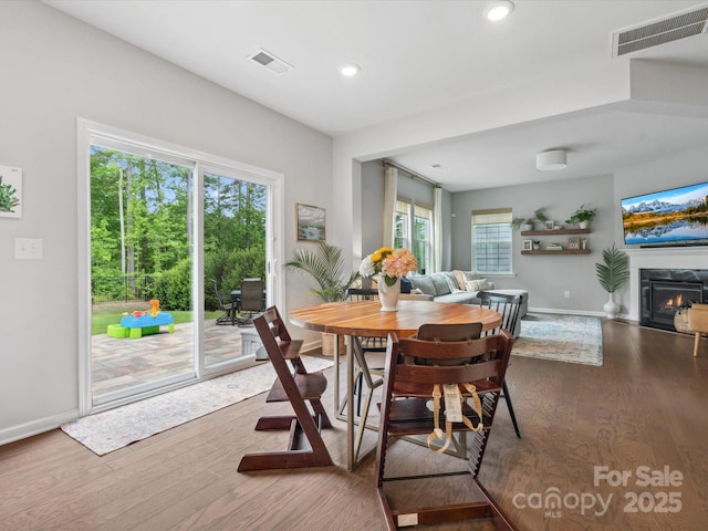 1008 Whipcord Dr, Waxhaw, NC 28173 - dining room with wood finished floors, recessed lighting, and a glass covered fireplace