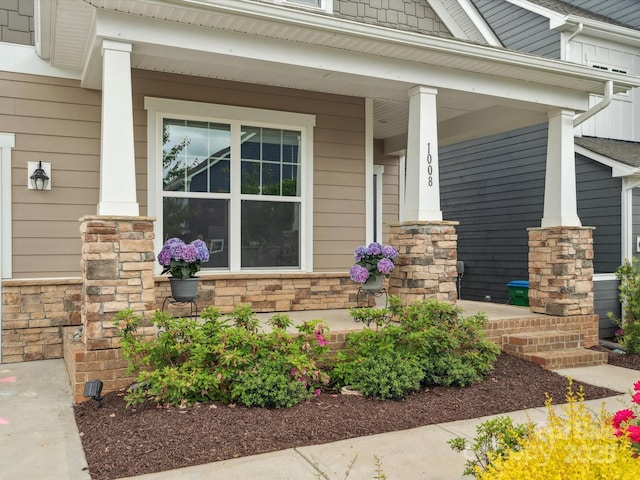 1008 Whipcord Dr, Waxhaw, NC 28173 - doorway to property featuring covered porch and stone siding