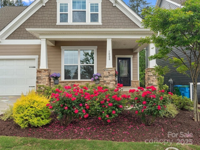 1008 Whipcord Dr, Waxhaw, NC 28173 - property entrance with a porch, stone siding, and a garage