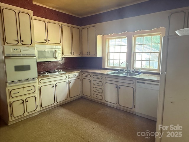 3985 1st Ave SW, Hickory, NC 28602 - kitchen featuring white appliances, light countertops, cream cabinets, tasteful backsplash, and ornamental molding