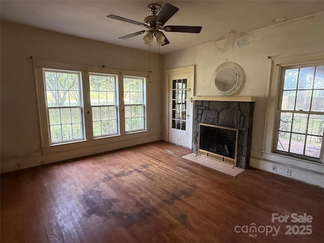 3985 1st Ave SW, Hickory, NC 28602 - unfurnished living room with wood finished floors, a stone fireplace, and a ceiling fan