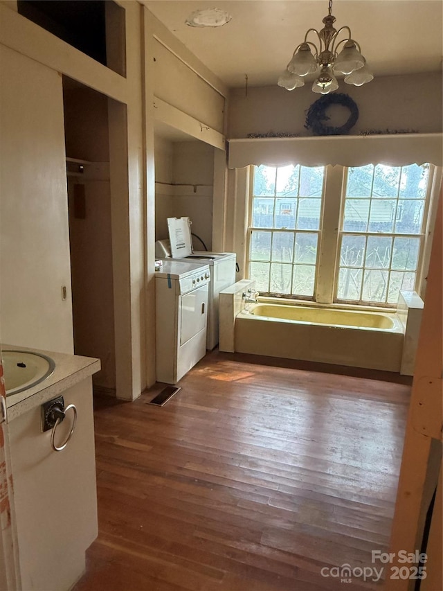 3985 1st Ave SW, Hickory, NC 28602 - kitchen with separate washer and dryer, wood finished floors, a chandelier, light countertops, and decorative light fixtures