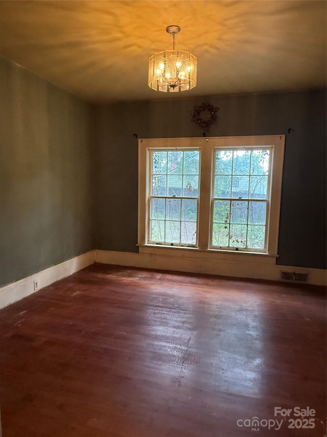3985 1st Ave SW, Hickory, NC 28602 - unfurnished room featuring wood finished floors and a chandelier