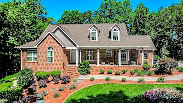 133 Sassafras Hill Dr, Rutherfordton, NC 28139 - cape cod home featuring brick siding, covered porch, a front lawn, and roof with shingles