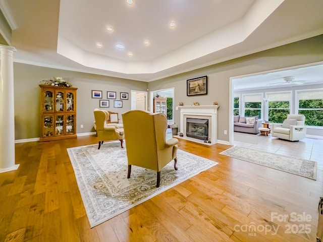 133 Sassafras Hill Dr, Rutherfordton, NC 28139 - living area with decorative columns, a fireplace with flush hearth, a raised ceiling, wood finished floors, and recessed lighting