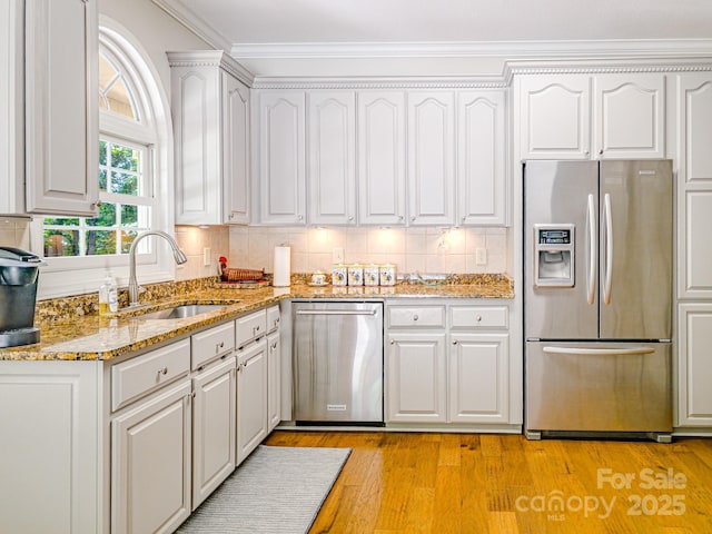 133 Sassafras Hill Dr, Rutherfordton, NC 28139 - kitchen featuring appliances with stainless steel finishes, ornamental molding, backsplash, white cabinets, and light stone countertops