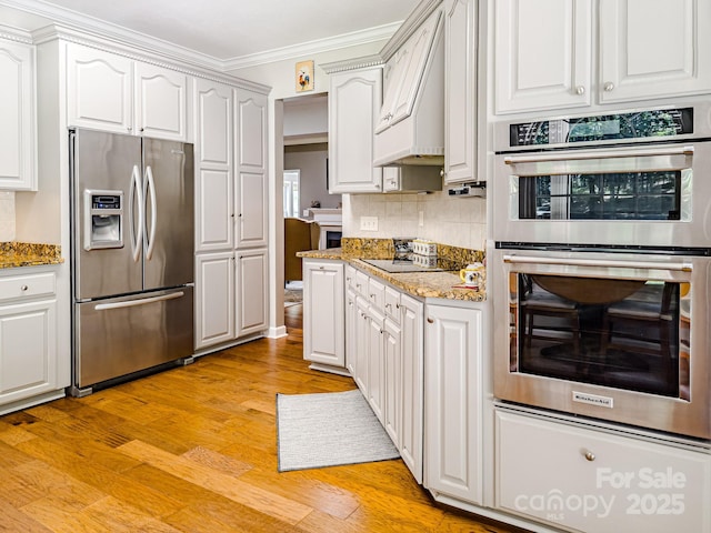 133 Sassafras Hill Dr, Rutherfordton, NC 28139 - kitchen with stainless steel appliances, crown molding, decorative backsplash, white cabinets, and light wood-type flooring