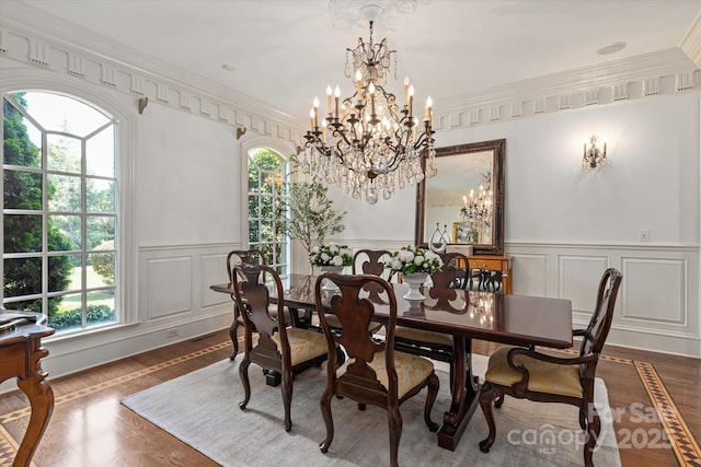9110 Woodhall Lake Dr, Waxhaw, NC 28173 - dining space featuring a decorative wall, a chandelier, dark wood-style floors, a wainscoted wall, and crown molding