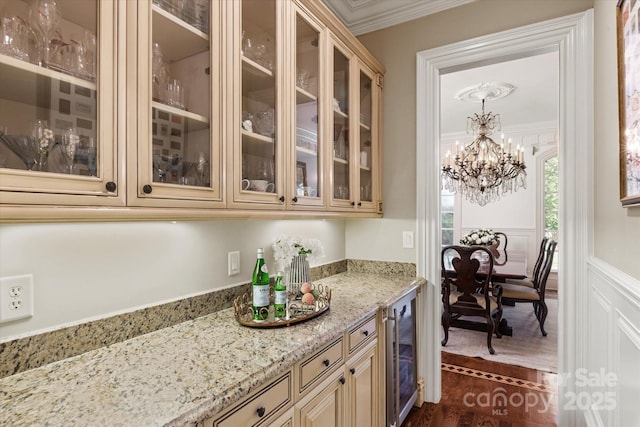 9110 Woodhall Lake Dr, Waxhaw, NC 28173 - bar featuring wine cooler, ornamental molding, a chandelier, wainscoting, and dark wood-style flooring