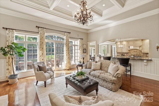 9110 Woodhall Lake Dr, Waxhaw, NC 28173 - living area featuring a chandelier, wood finished floors, crown molding, coffered ceiling, and healthy amount of natural light