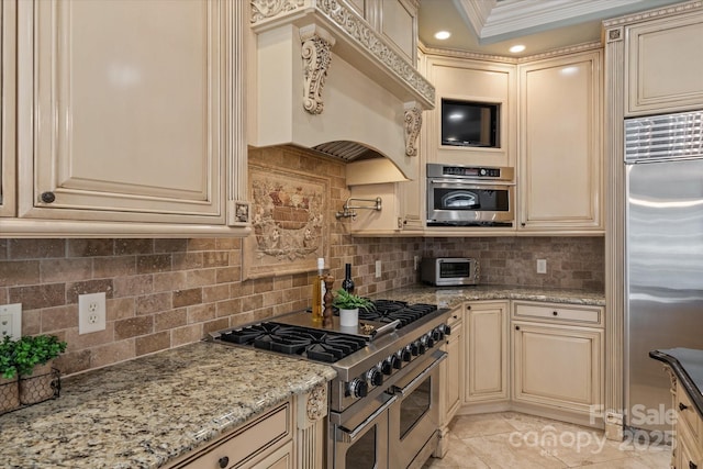 9110 Woodhall Lake Dr, Waxhaw, NC 28173 - kitchen featuring cream cabinets, high end appliances, and decorative backsplash