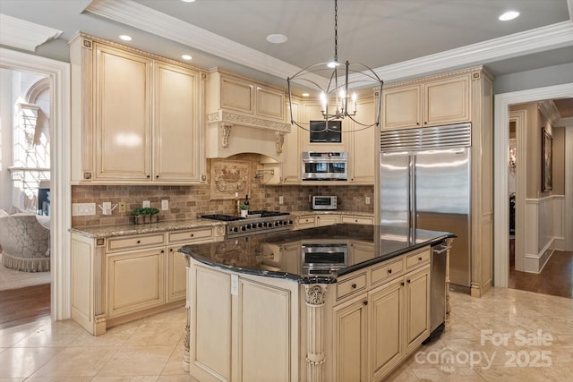 9110 Woodhall Lake Dr, Waxhaw, NC 28173 - kitchen featuring cream cabinets, built in refrigerator, tasteful backsplash, crown molding, and recessed lighting