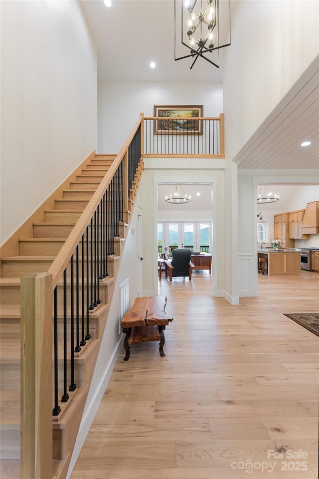 48 Falling Leaves Ln, Hendersonville, NC 28792 - stairs with a chandelier, a high ceiling, recessed lighting, and wood finished floors