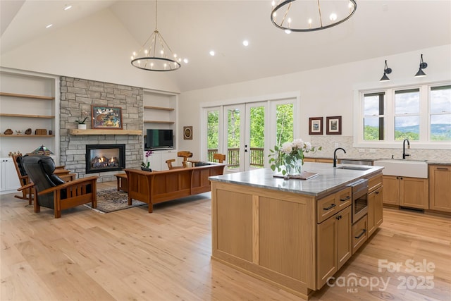 48 Falling Leaves Ln, Hendersonville, NC 28792 - kitchen with a chandelier, built in features, stainless steel microwave, high vaulted ceiling, and light wood-style flooring