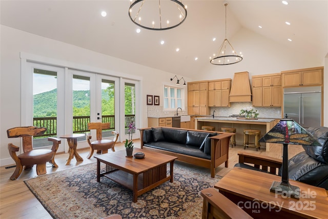 48 Falling Leaves Ln, Hendersonville, NC 28792 - living area featuring french doors, recessed lighting, a chandelier, high vaulted ceiling, and light wood-type flooring