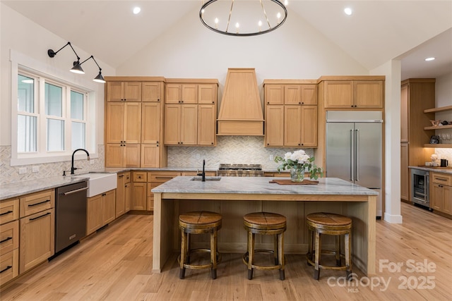 48 Falling Leaves Ln, Hendersonville, NC 28792 - kitchen with custom range hood, appliances with stainless steel finishes, wine cooler, high vaulted ceiling, and backsplash