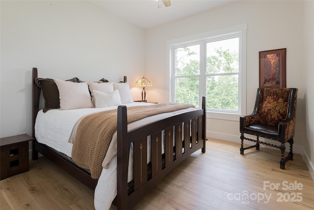 48 Falling Leaves Ln, Hendersonville, NC 28792 - bedroom featuring multiple windows, light wood-style floors, and ceiling fan