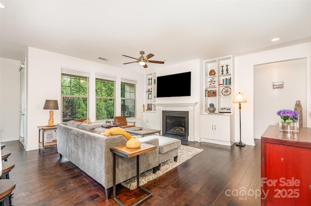 11225 Black Brant Ln, Charlotte, NC 28278 - living area featuring a fireplace with flush hearth, ceiling fan, dark wood-type flooring, built in features, and recessed lighting