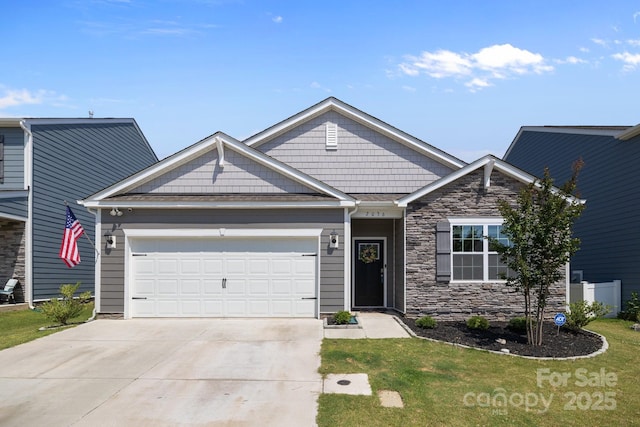 2036 Vanderlyn St, Monroe, NC 28112 - craftsman-style house featuring an attached garage, driveway, a front lawn, and stone siding