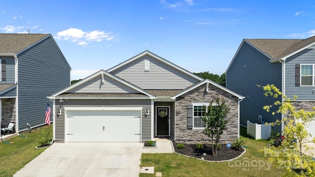 2036 Vanderlyn St, Monroe, NC 28112 - craftsman inspired home featuring an attached garage, driveway, stone siding, and a front lawn