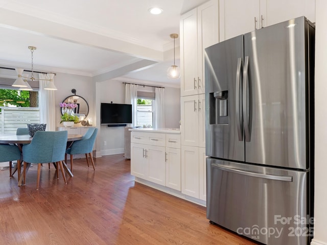 4618 Emory Ln, Charlotte, NC 28211 - kitchen with stainless steel fridge with ice dispenser, crown molding, white cabinetry, light wood finished floors, and recessed lighting