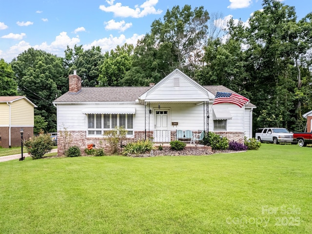 409 E 18th St, Kannapolis, NC 28083 - view of front of property with a front lawn, a chimney, roof with shingles, and brick siding