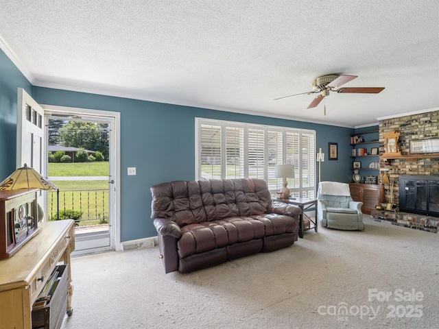 409 E 18th St, Kannapolis, NC 28083 - living room featuring a textured ceiling, ornamental molding, carpet, healthy amount of natural light, and ceiling fan