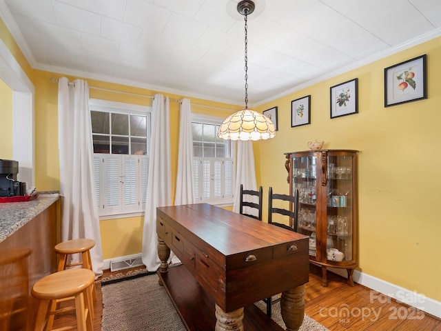 409 E 18th St, Kannapolis, NC 28083 - dining space featuring ornamental molding and wood finished floors