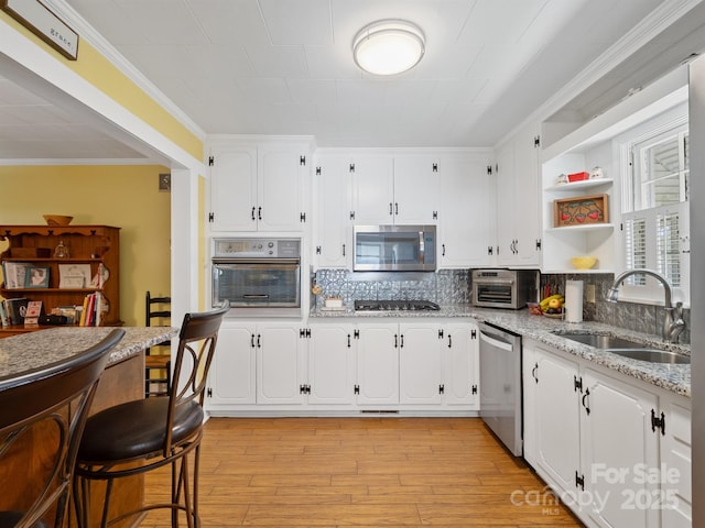 409 E 18th St, Kannapolis, NC 28083 - kitchen with appliances with stainless steel finishes, white cabinetry, open shelves, and crown molding