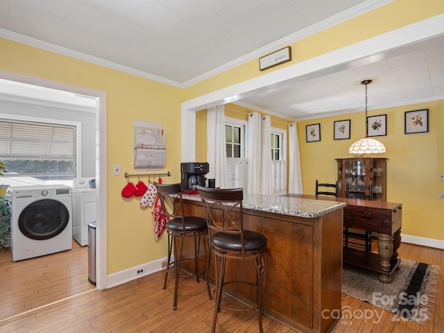 409 E 18th St, Kannapolis, NC 28083 - indoor dry bar with washing machine and dryer, crown molding, light wood-style flooring, and hanging light fixtures