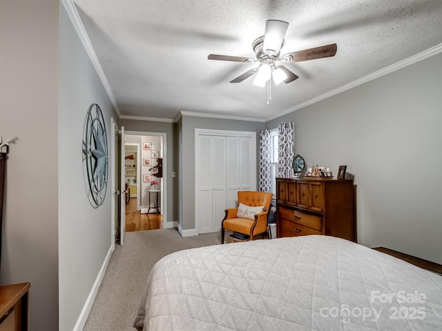 409 E 18th St, Kannapolis, NC 28083 - bedroom with a closet, carpet floors, a textured ceiling, crown molding, and a ceiling fan
