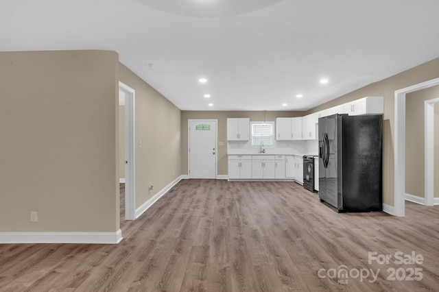 6208 Karenstone Dr, Charlotte, NC 28215 - kitchen featuring fridge with ice dispenser, black electric range, light wood-style floors, white cabinetry, and recessed lighting