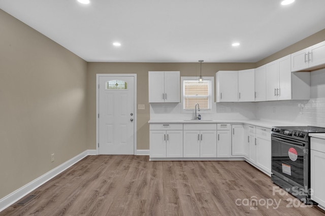 6208 Karenstone Dr, Charlotte, NC 28215 - kitchen featuring stainless steel electric range oven, plenty of natural light, recessed lighting, white cabinets, and decorative backsplash