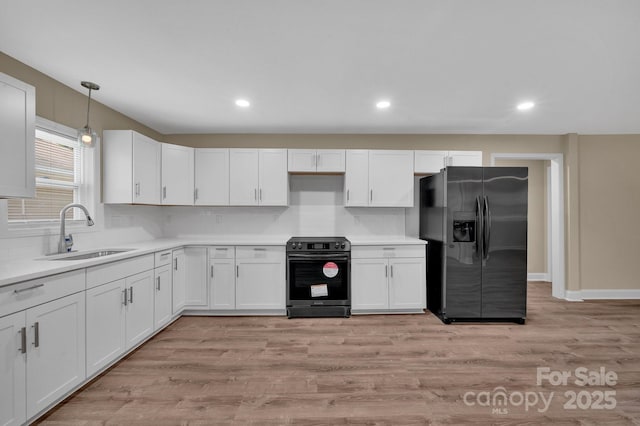 6208 Karenstone Dr, Charlotte, NC 28215 - kitchen with stainless steel range with electric cooktop, refrigerator with ice dispenser, white cabinets, light wood-style floors, and light countertops