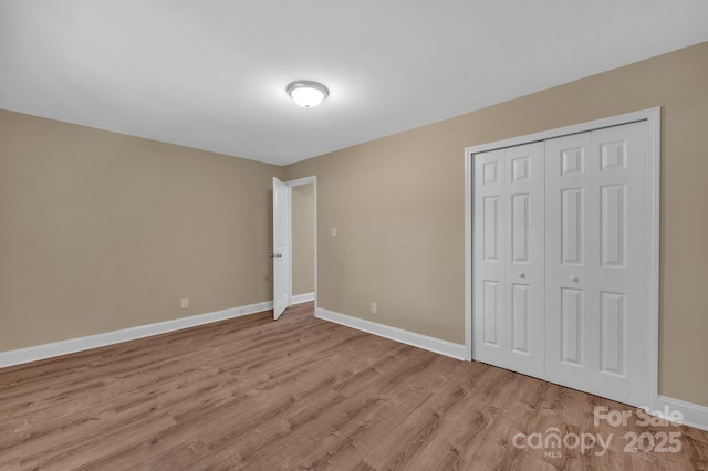 6208 Karenstone Dr, Charlotte, NC 28215 - unfurnished bedroom with light wood-type flooring and a closet