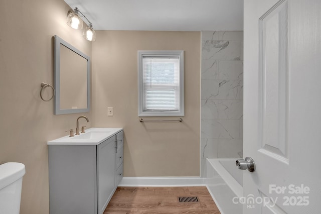 6208 Karenstone Dr, Charlotte, NC 28215 - bathroom with vanity, wood finished floors, and washtub / shower combination
