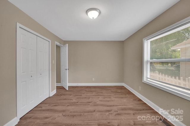 6208 Karenstone Dr, Charlotte, NC 28215 - unfurnished bedroom with wood finished floors and a closet