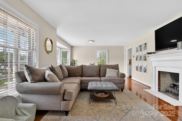 601 Pennell St NE, Lenoir, NC 28645 - living area featuring wood finished floors and a fireplace with flush hearth