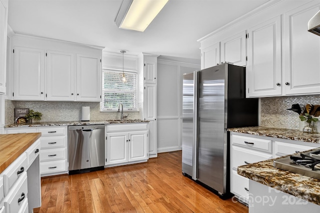 601 Pennell St NE, Lenoir, NC 28645 - kitchen featuring stainless steel appliances, white cabinets, and tasteful backsplash