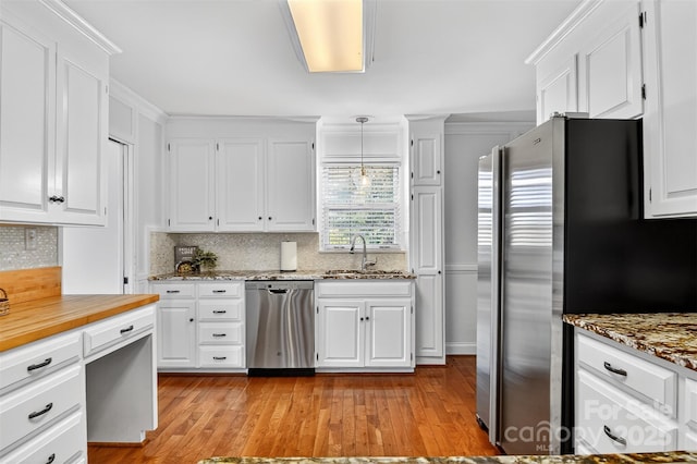 601 Pennell St NE, Lenoir, NC 28645 - kitchen featuring stainless steel appliances, white cabinetry, decorative backsplash, and light wood-style floors